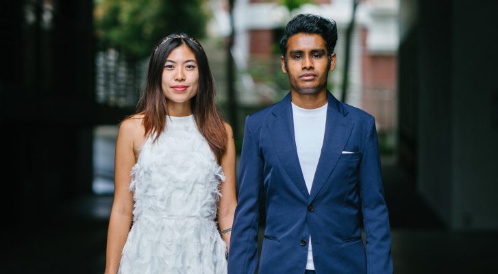 Woman in white sleeveless dress and man on blue blazer