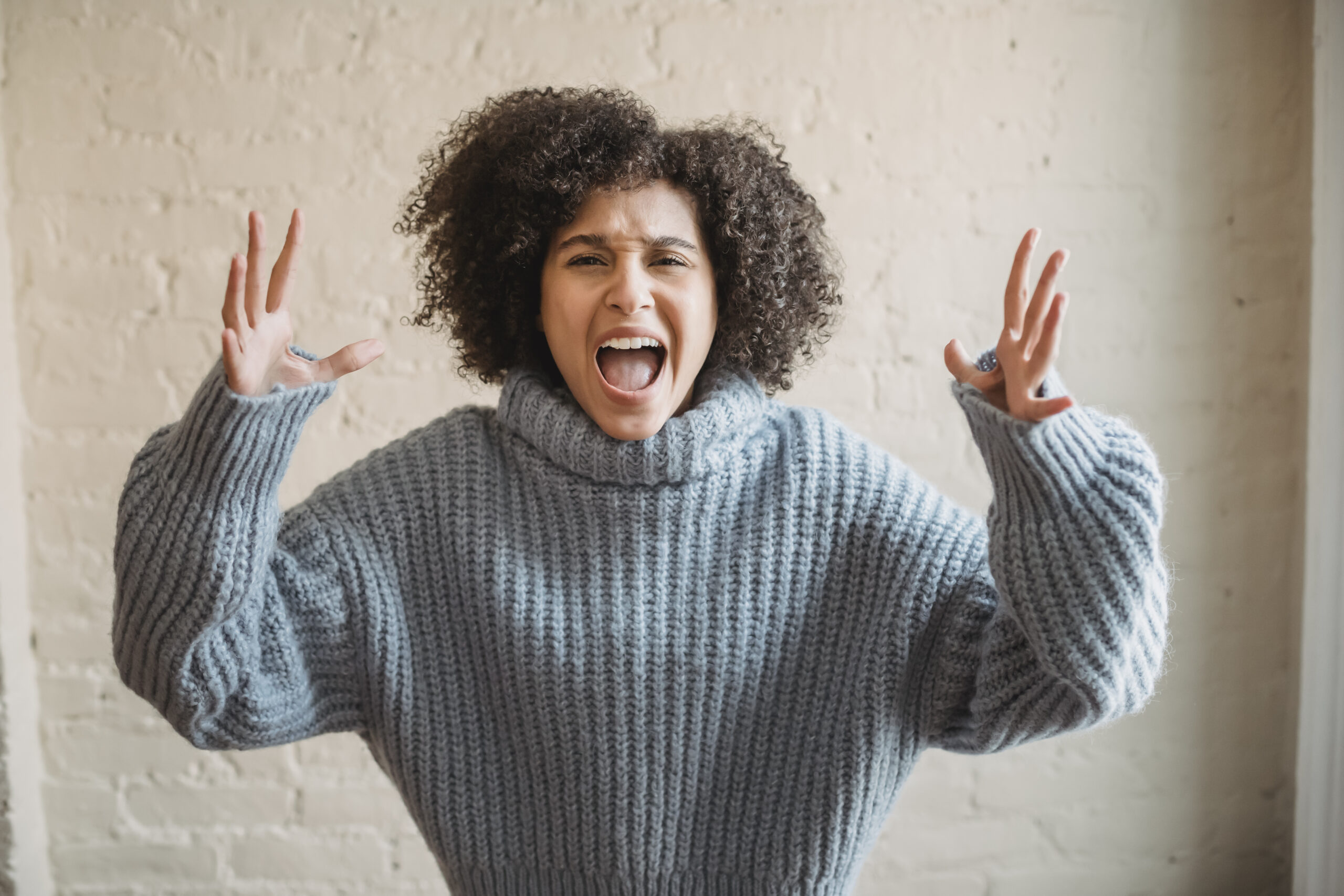 Angry black woman screaming in room
