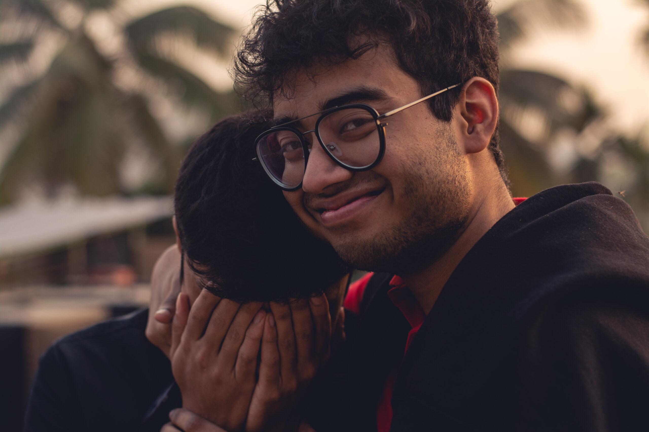 Men with black hair smiling and crying